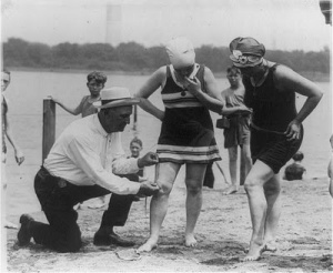 In the 19s0 don't get those bathing suits too short or the man whose job it was to measure to make sure bathing suits were the proper length might make you get back in your street clothes. You could also be cited for indecent exposure. 